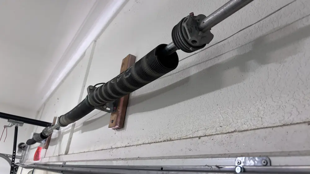 A garage door torsion spring above the door